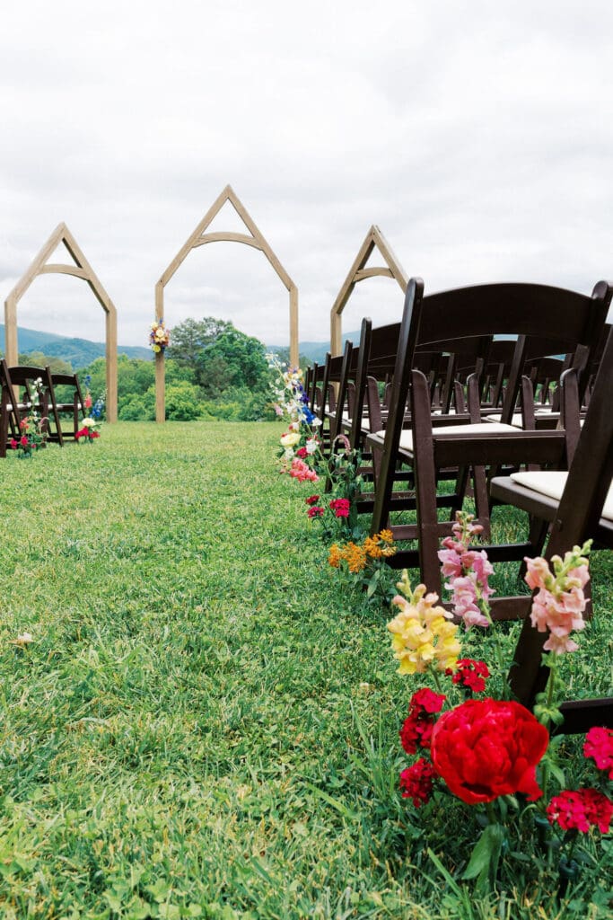 lose-up of blush and yellow flower arrangements for wedding ceremony