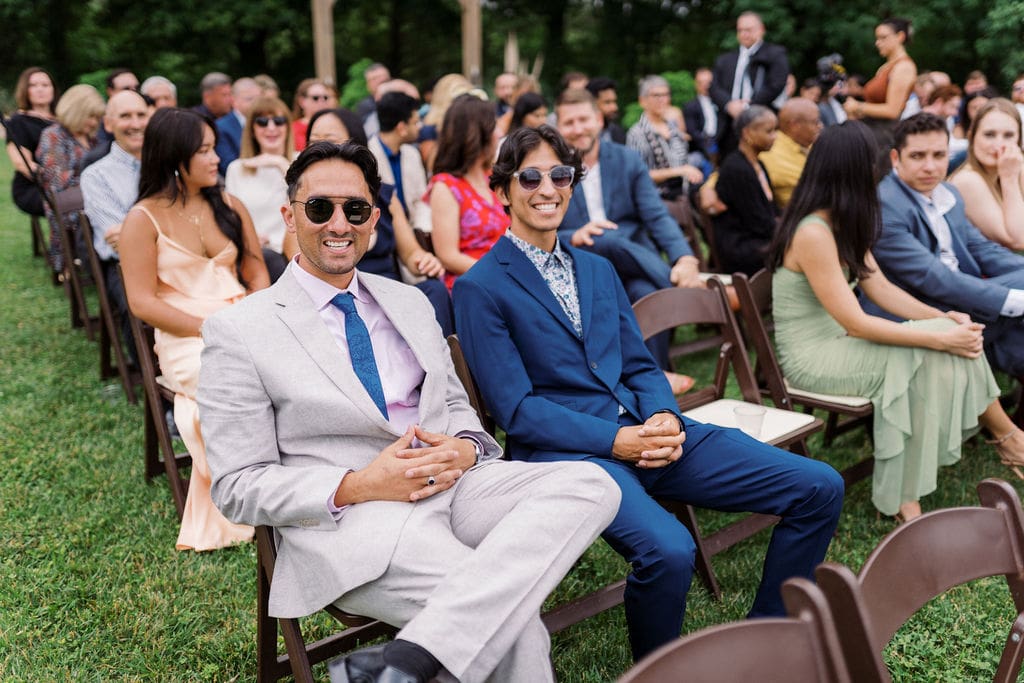guests sit at ceremony site for harpers vineyard may wedding