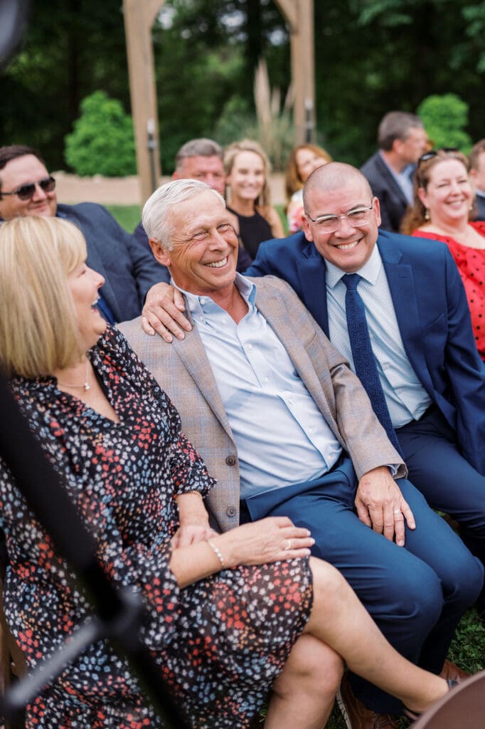 guests laughing during wedding ceremony at harpers vineyard