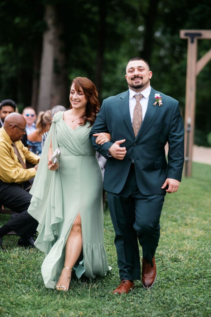 groom and mother walk down aisle at harpers vineyard in townsend tennessee