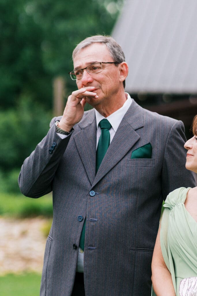 Emotional dad seeing bride for the first time at vineyard ceremony.