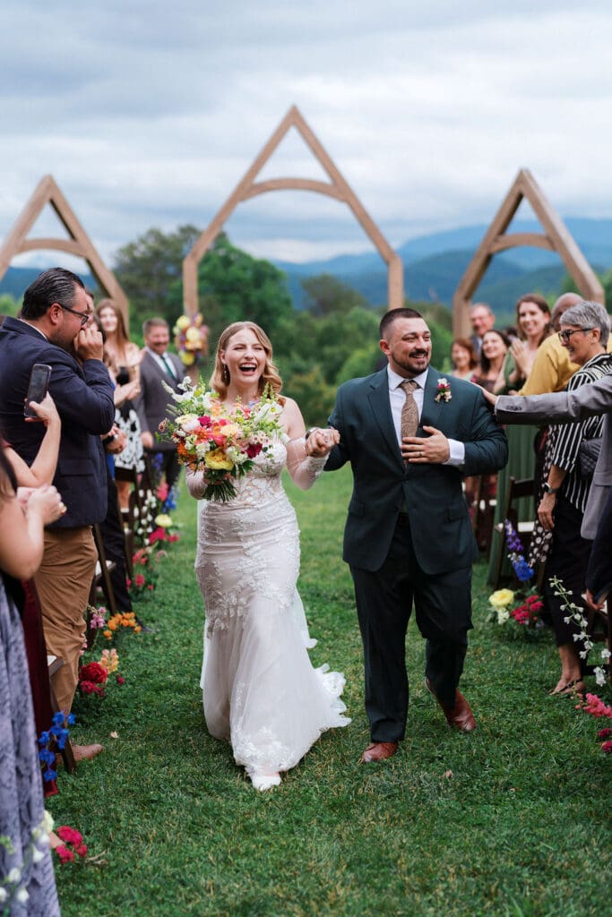 Bride and groom walking down aisle at Harper’s Vineyard wedding in May