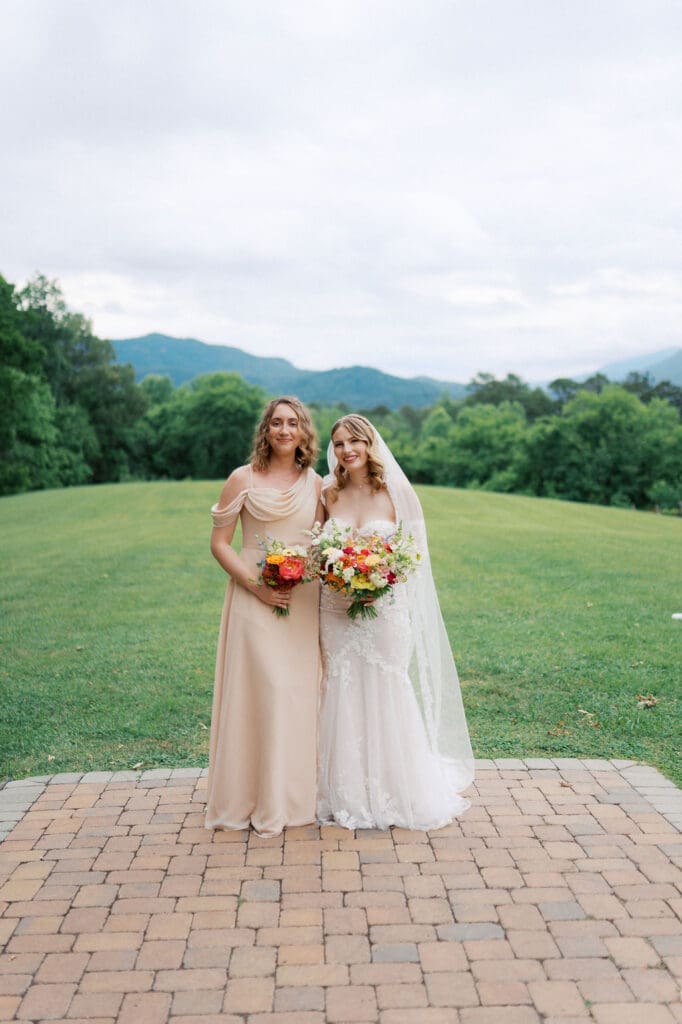 bride and bridesmaid smiling at harpers vineyard wedding venue.