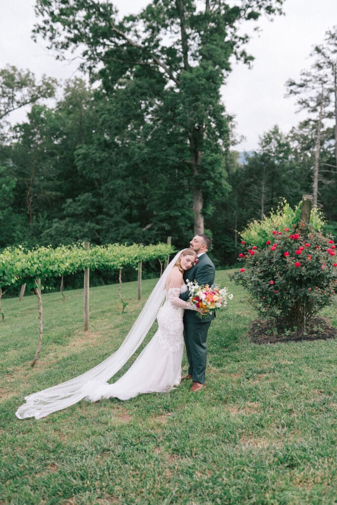 Bride and groom kissing at sunset at Harper’s Vineyard wedding in May