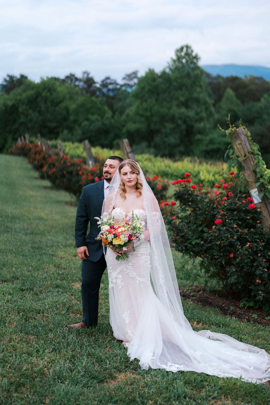 Bride and groom posing at sunset at Harper’s Vineyard wedding in May