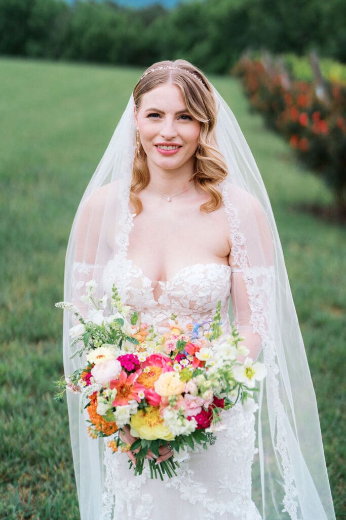 Romantic wedding portrait in Tennessee vineyard with rolling hills background.