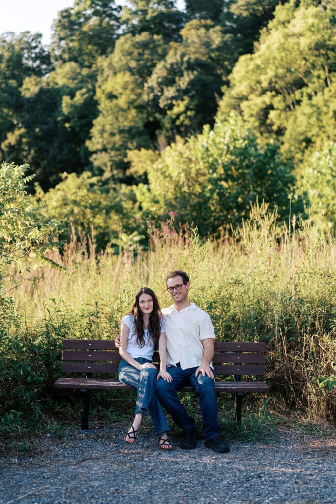 Knoxville couple on bench for engagement portraits at Seven Islands State Birding Park