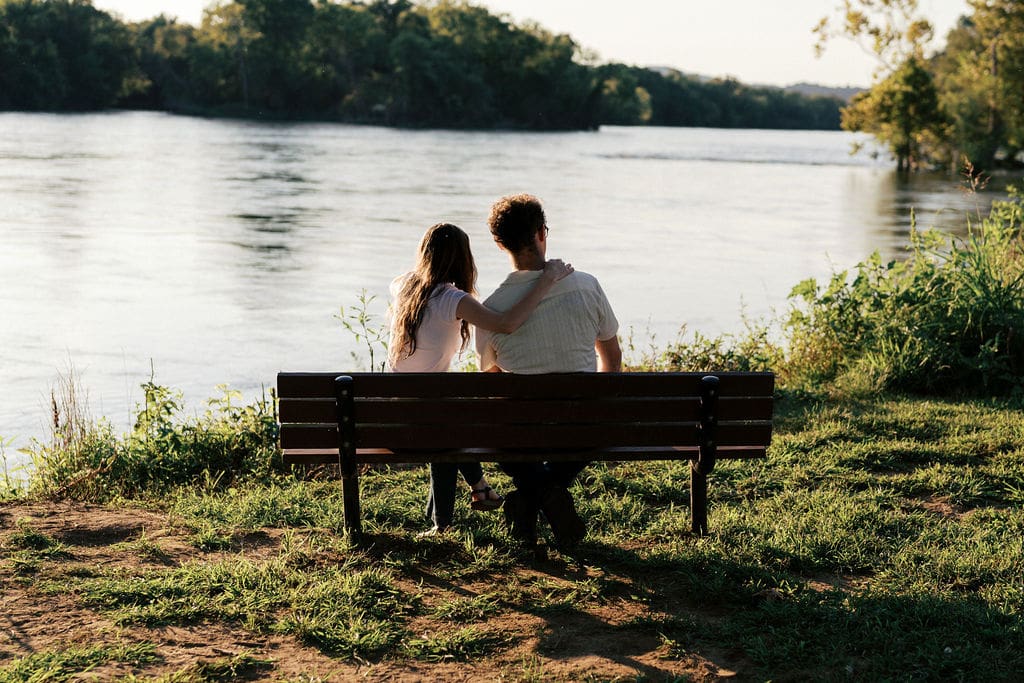 Knoxville couple on bench for engagement portraits at Seven Islands State Birding Park