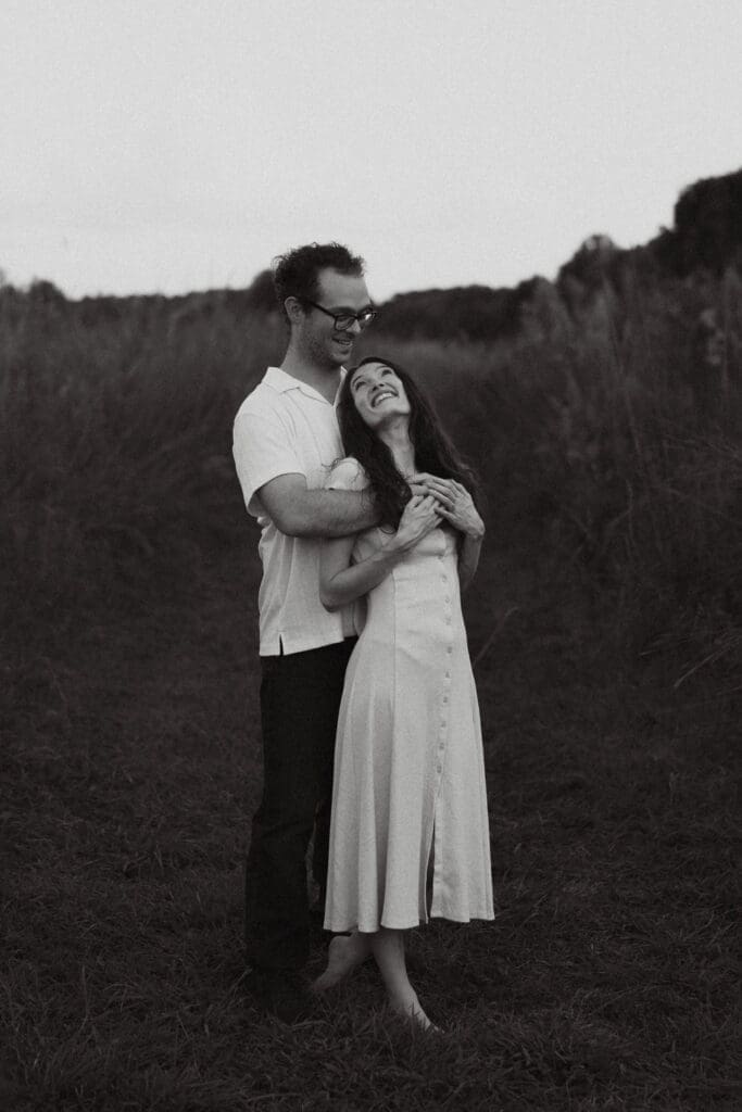 fiancees hug in field at seven islands state birding park in knoxville tennessee