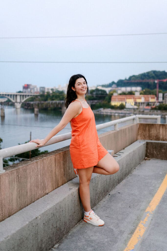 Rachel smiling on top of G10 garage during her senior photo session at the University of Tennessee Knoxville