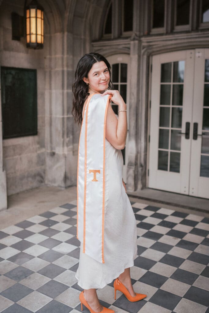 utk senior photos in white dress and orange heels at ayres hall in knoxville tennessee