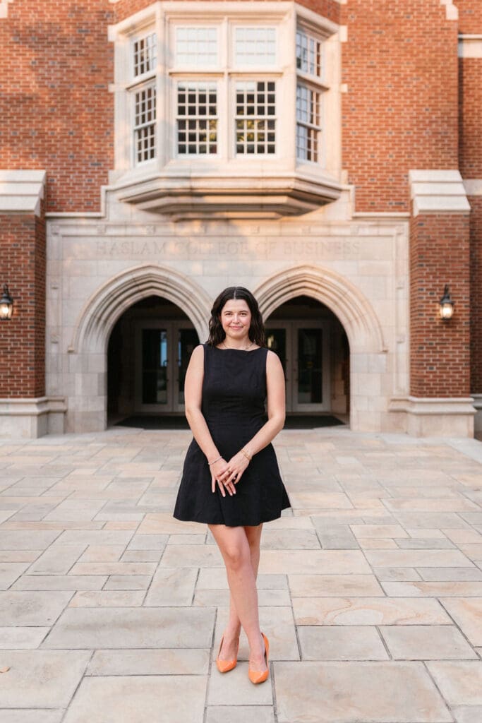 marketing major takes senior photos in front of the haslam college of business in knoxville tennessee