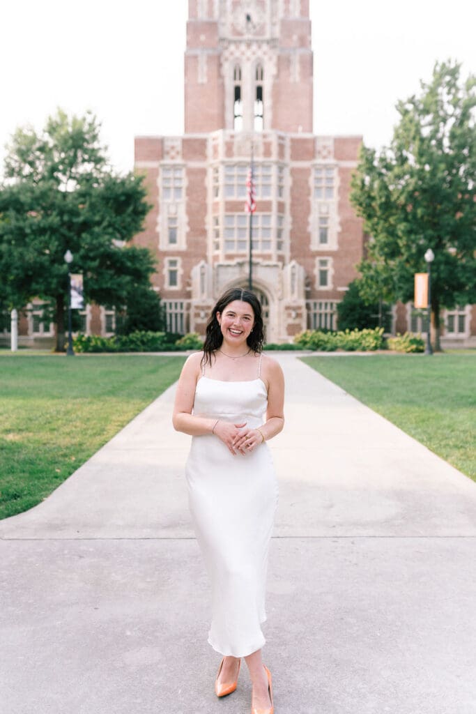 Rachel smiling in front of Ayres Hall during her senior photo session at the University of Tennessee Knoxville