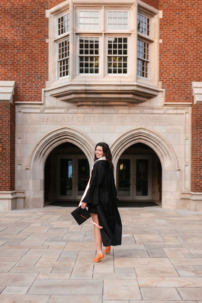 marketing major takes senior photos in front of the haslam college of business in knoxville tennessee