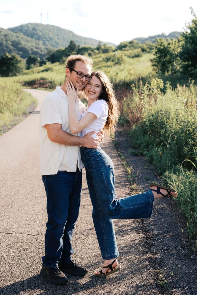couple poses on walking trail at seven islands park in knoxville tn for summer engagement photos