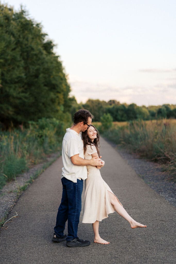 fiances hug on walking trail at seven islands state birding park in knoxville tennessee