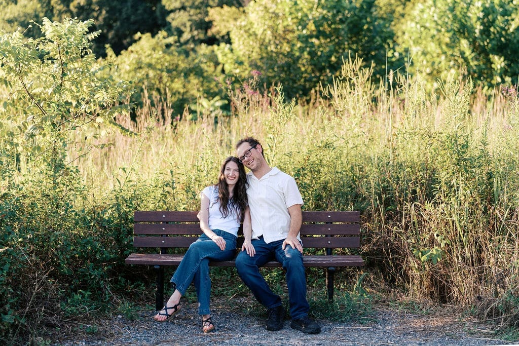 Knoxville couple on bench for engagement portraits at Seven Islands State Birding Park