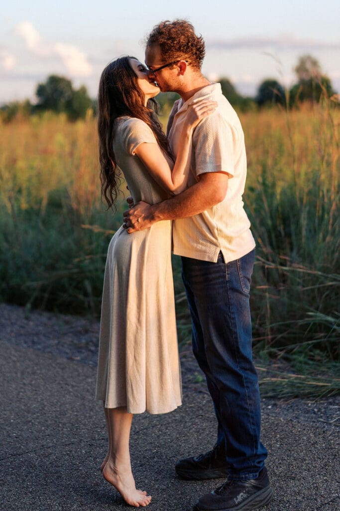 couple kisses during golden hour at seven islands state birding park in knoxville tennessee