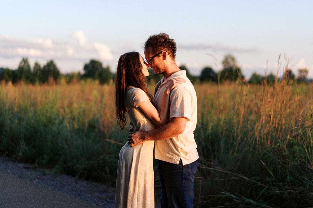 couple hugs during golden hour at seven islands state birding park in knoxville tennessee