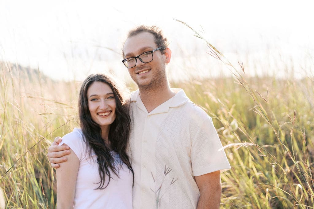 Couple standing in a field at Seven Islands during their Knoxville engagement session