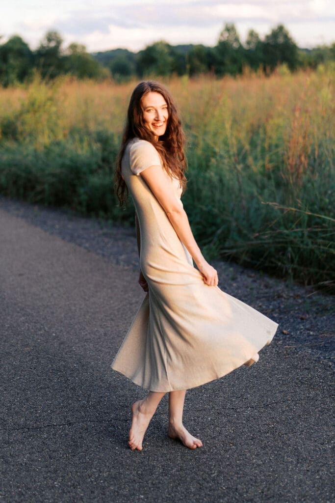 woman dances during golden hour at seven islands state birding park in knoxville tennessee