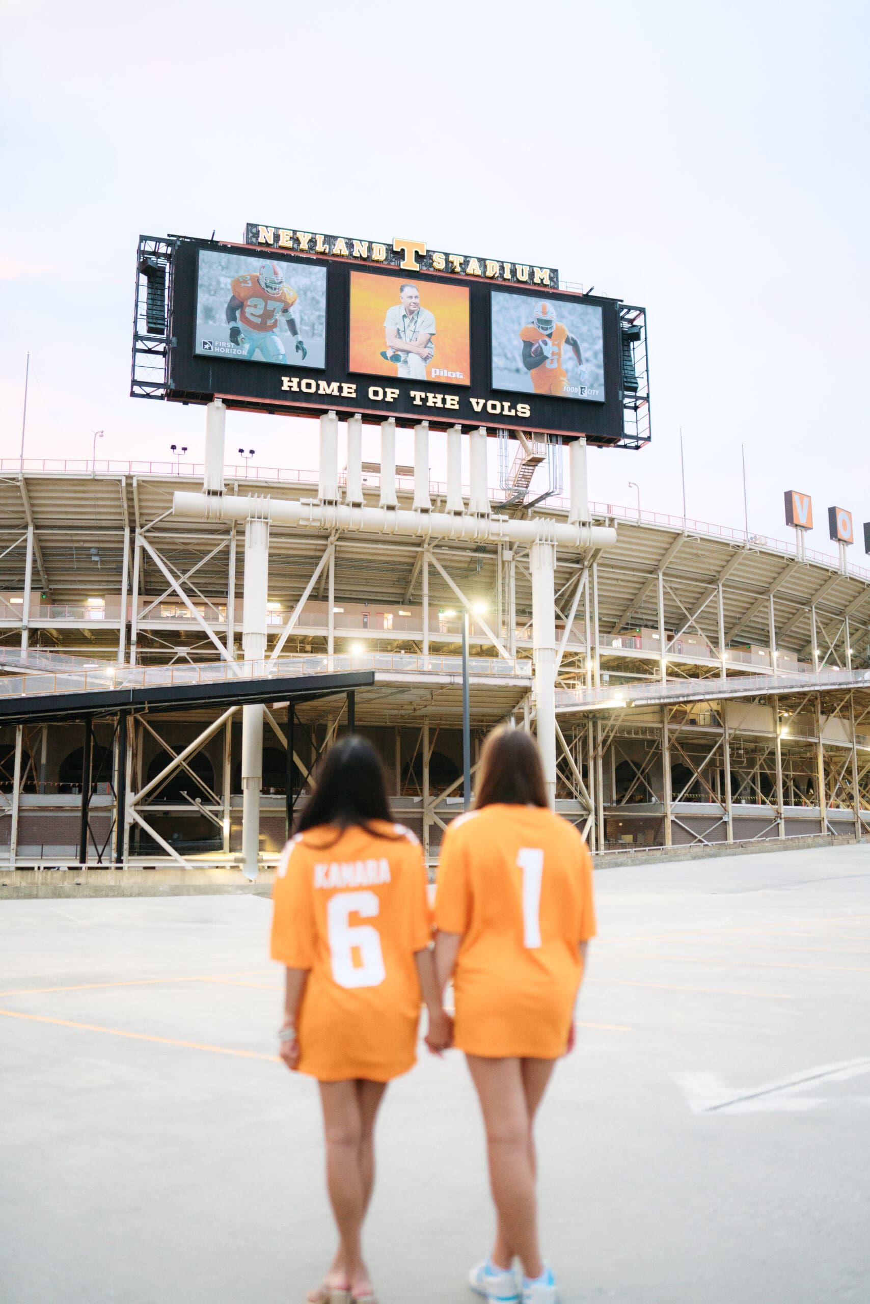 two girls in orange vols jersey at g10 garage by neyland stadium in knoxville