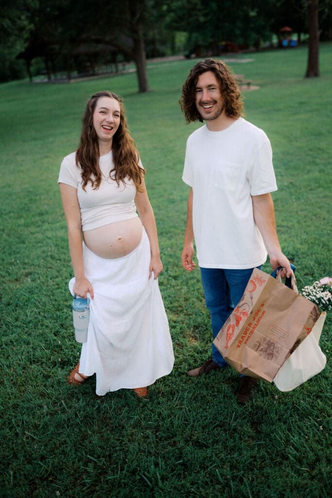 Candid photo of couple laughing during maternity photo session at Cove Lake State Park near Knoxville