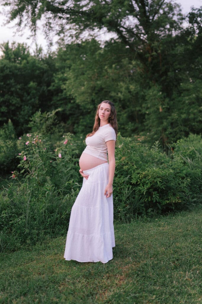 Maternity photo of an expecting mother standing in a field at Cove Lake State Park in Tennessee taken by Knoxville maternity photographer