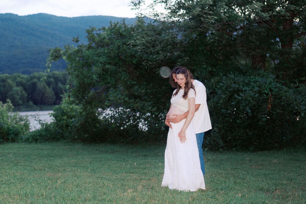 Flash maternity photo of couple embracing during sunset at Cove Lake State Park, captured by Knoxville photographer