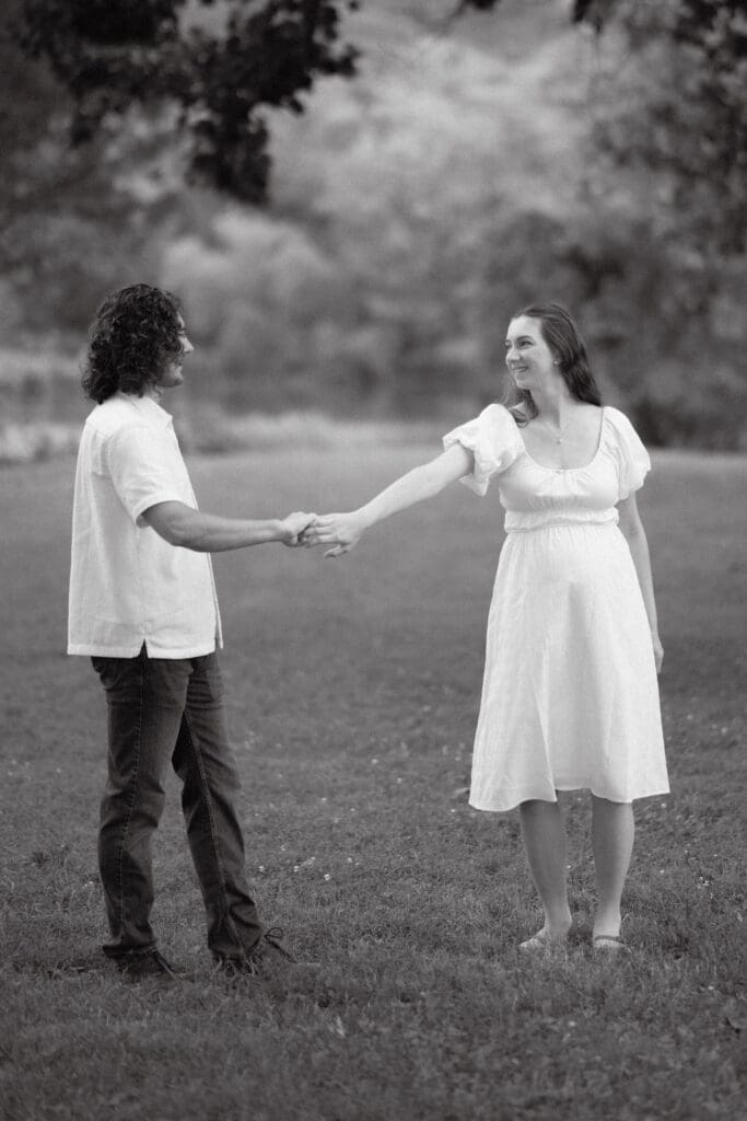 Black and white maternity portrait of parents dancing at Cove Lake State Park, Tennessee