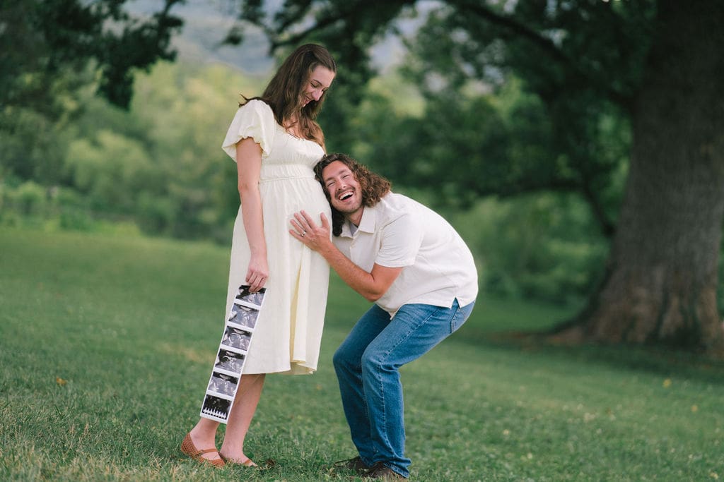 Couple embracing in wooded area during maternity session at Cove Lake State Park, Tennessee